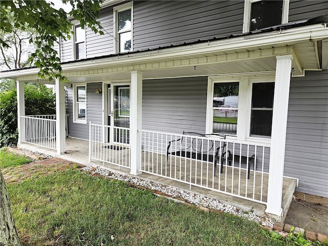 view of exterior entry with covered porch