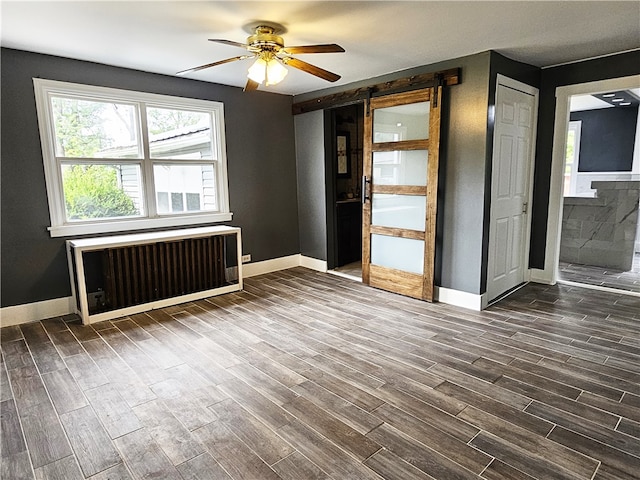 interior space featuring radiator heating unit, ceiling fan, and hardwood / wood-style floors