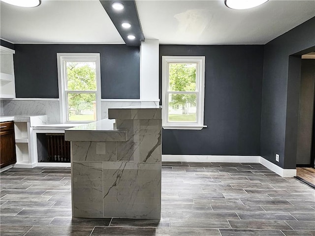 interior space with wood tiled floor, baseboards, and recessed lighting