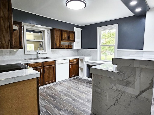 kitchen with wood finish floors, a sink, light countertops, dishwasher, and open shelves