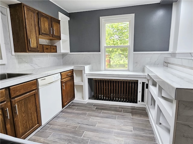 kitchen with sink, white dishwasher, and backsplash