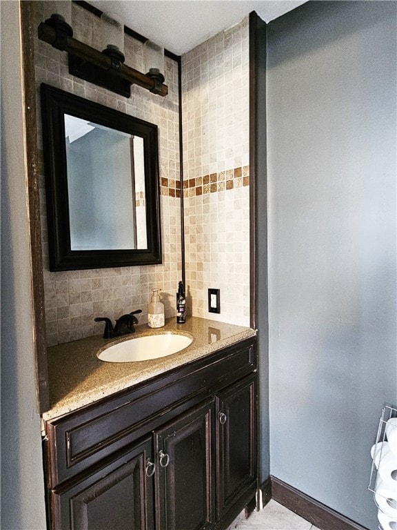 bathroom featuring vanity, backsplash, and tile walls