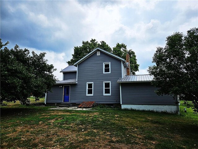 back of house with a lawn