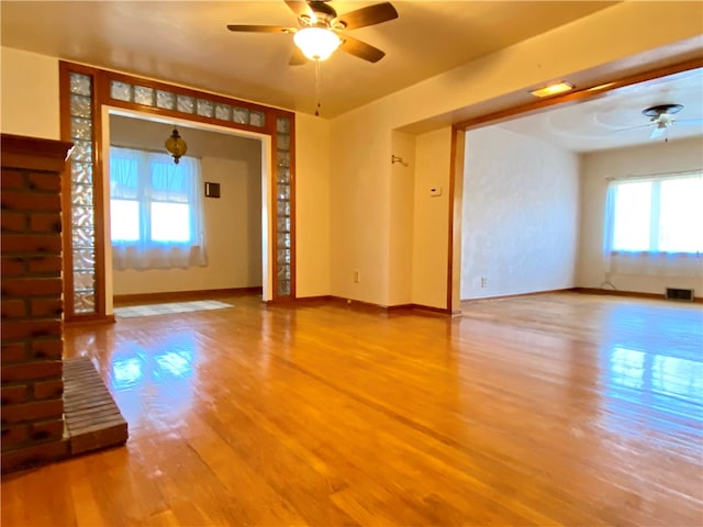 empty room featuring ceiling fan and hardwood / wood-style floors