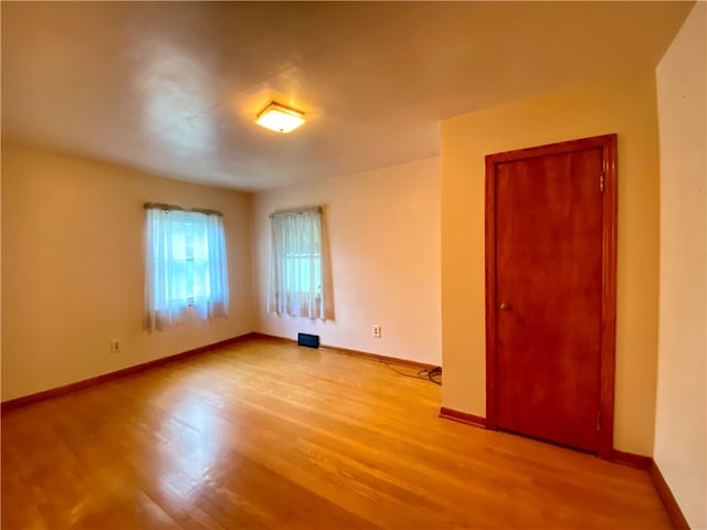 unfurnished room with light hardwood / wood-style flooring