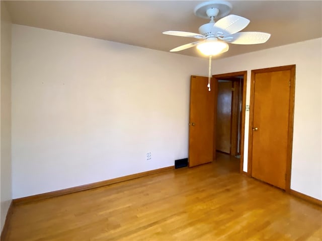 empty room with light hardwood / wood-style floors and ceiling fan