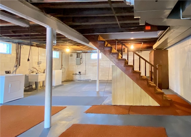 basement featuring washer / dryer and sink