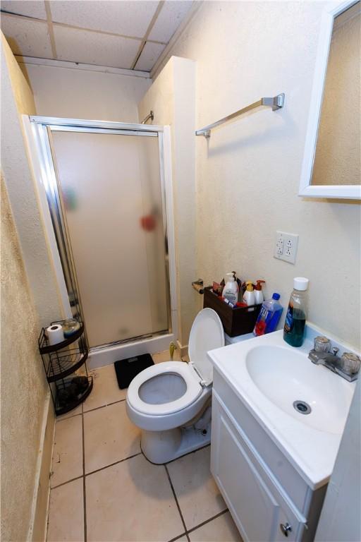 213 2nd St, Elco, PA 15434 - bathroom with a stall shower, toilet, vanity, tile patterned floors, and a drop ceiling