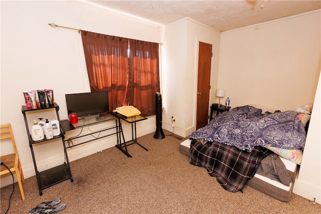 bedroom with crown molding and carpet floors