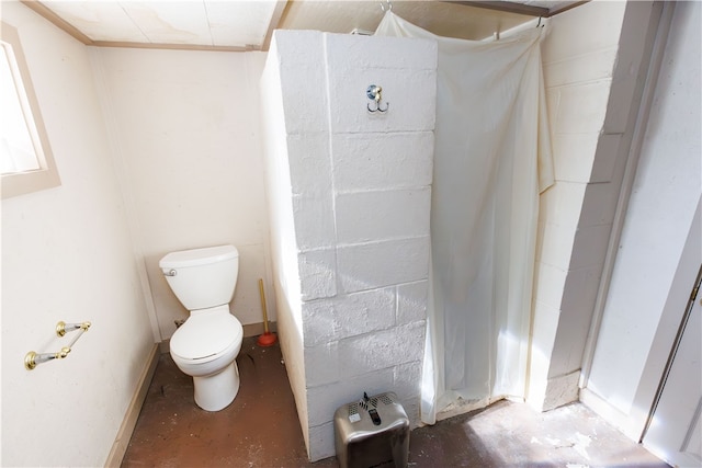 bathroom featuring toilet and concrete floors