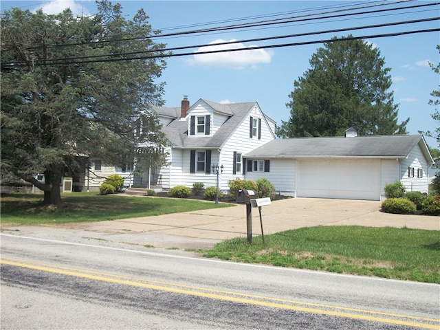 cape cod house with a garage and a front yard