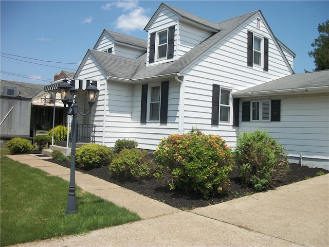 view of property exterior featuring a lawn