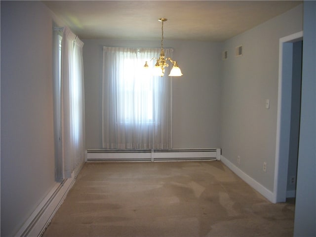 spare room with a notable chandelier, baseboard heating, and hardwood / wood-style flooring