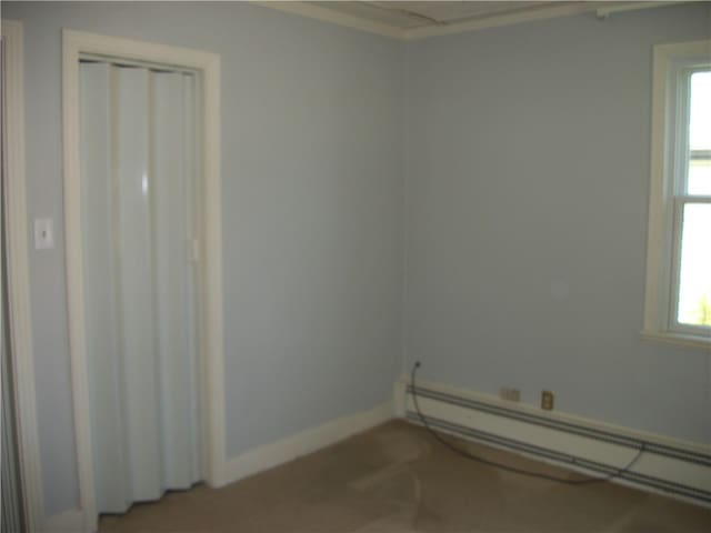 unfurnished room with a baseboard radiator