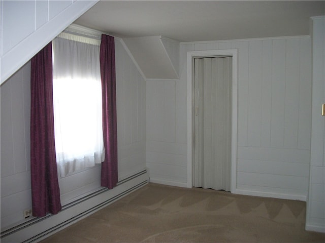 additional living space with a baseboard radiator and carpet floors