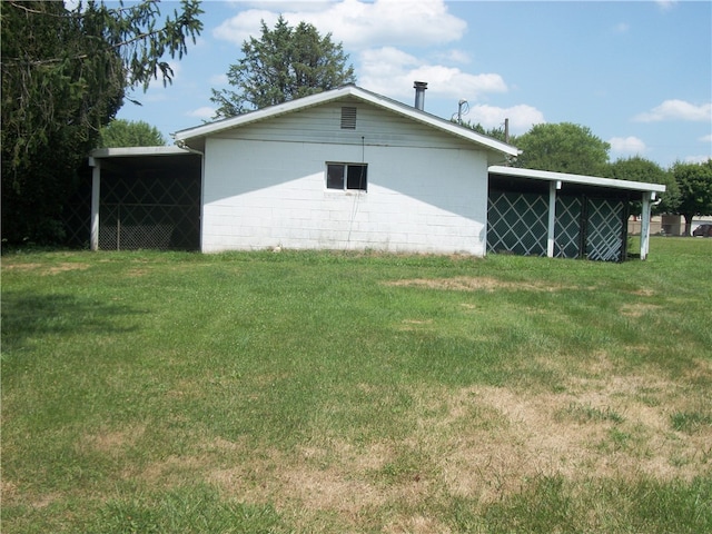 view of side of property featuring a carport and a lawn