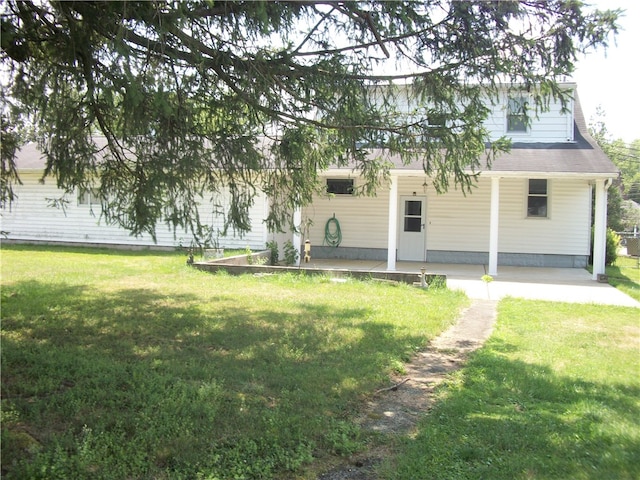 back of property featuring a lawn