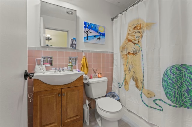 bathroom featuring tasteful backsplash, tile walls, toilet, tile patterned floors, and vanity