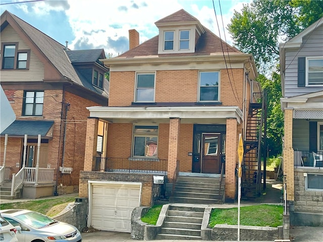 view of front of home with a garage and a porch