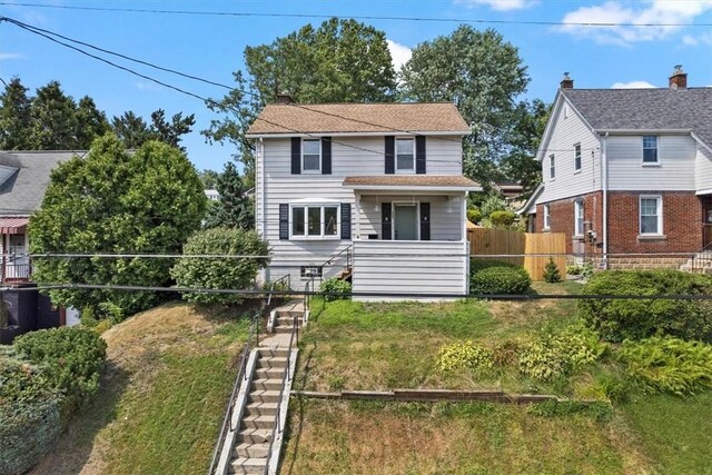 front facade with a front yard