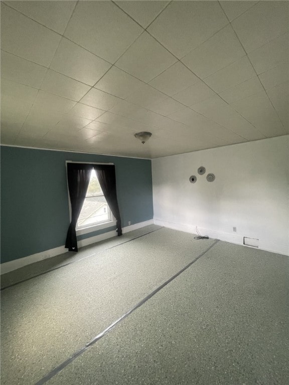 empty room featuring a paneled ceiling