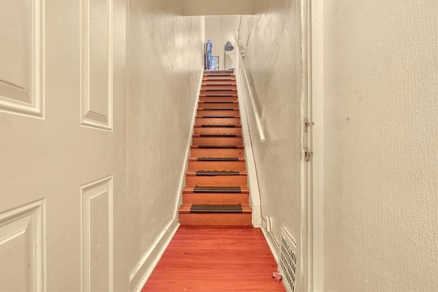 staircase featuring hardwood / wood-style floors