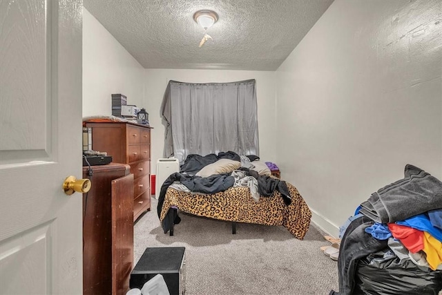 bedroom featuring a textured ceiling and carpet flooring