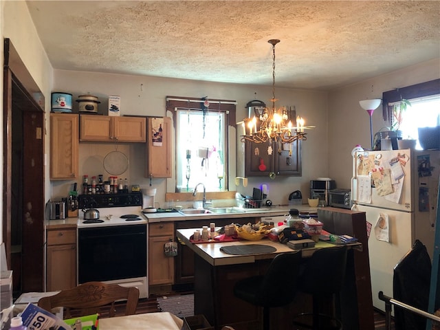 kitchen with a textured ceiling, plenty of natural light, and white appliances