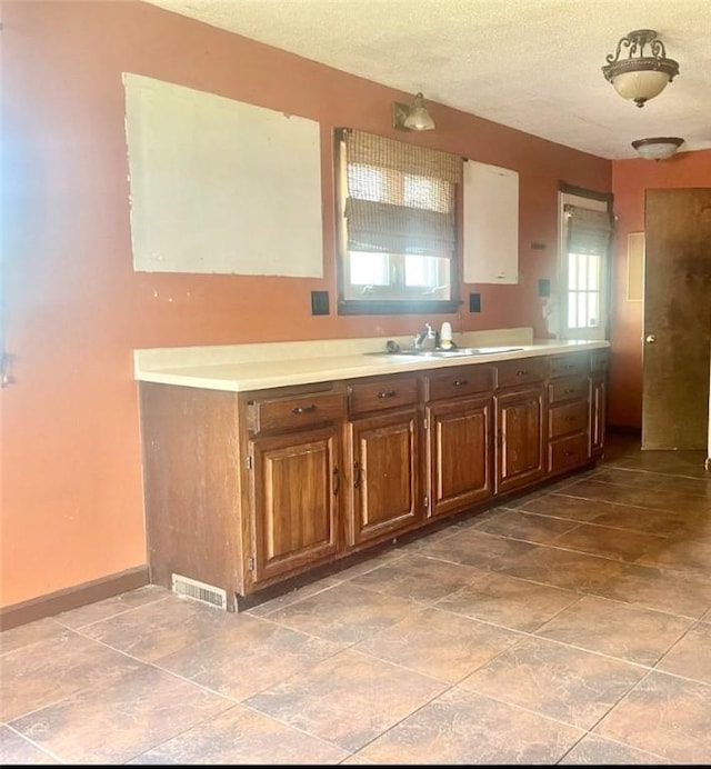 kitchen featuring sink and a textured ceiling