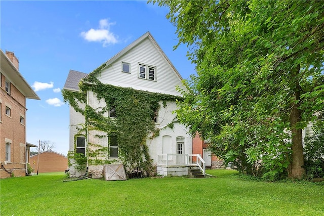 rear view of house with a yard and brick siding