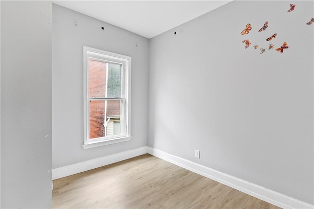 unfurnished room featuring light wood-style flooring and baseboards