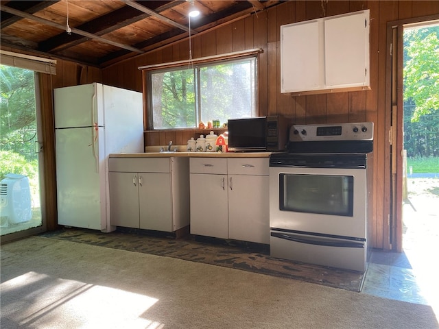 kitchen with wooden ceiling, stainless steel electric range, lofted ceiling with beams, and plenty of natural light