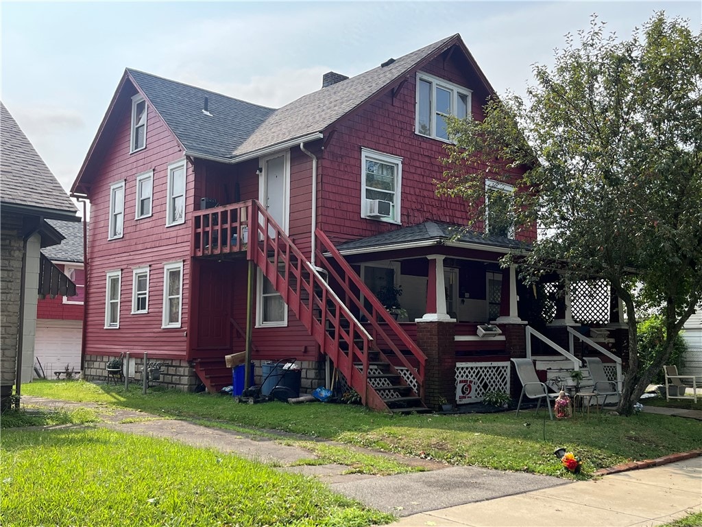 back of house with a lawn