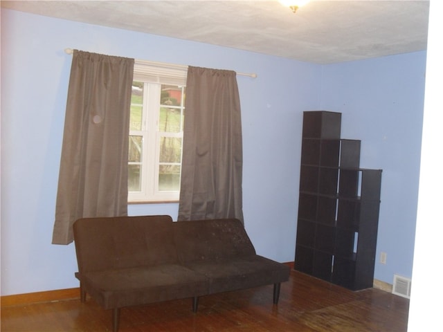 unfurnished room featuring a textured ceiling and dark hardwood / wood-style floors