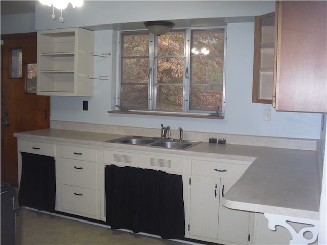 kitchen with white cabinetry and sink