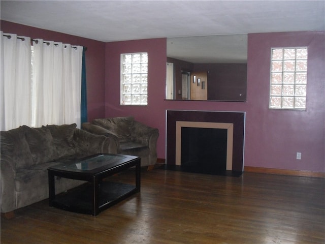 living room with dark hardwood / wood-style flooring and plenty of natural light