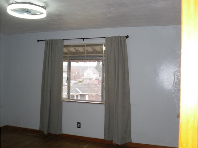 spare room featuring dark wood-type flooring