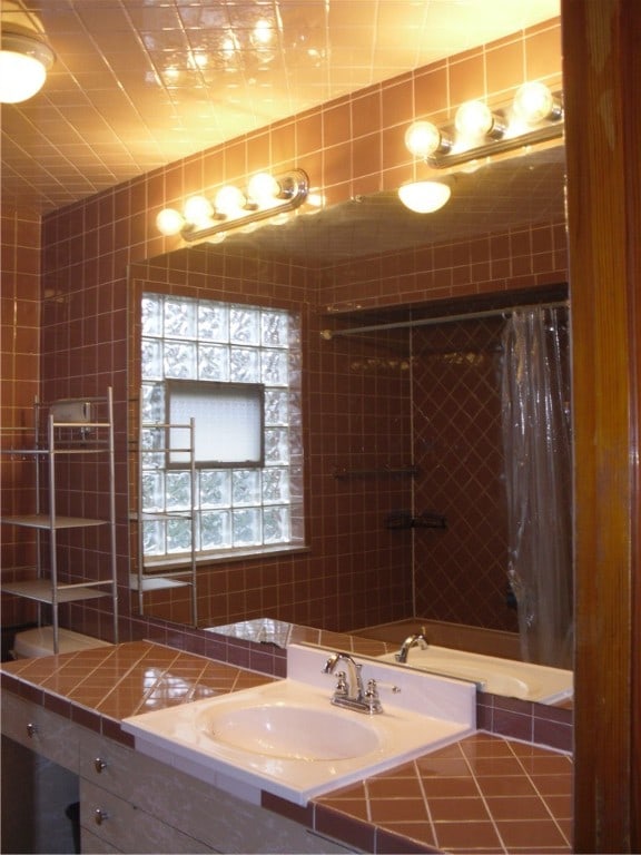 bathroom with vanity and curtained shower