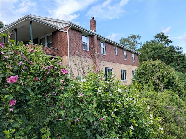 view of side of home featuring a balcony