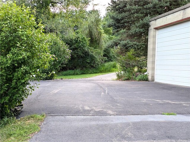 view of parking / parking lot featuring a garage