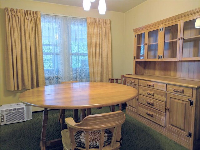 carpeted dining room featuring a wall mounted air conditioner