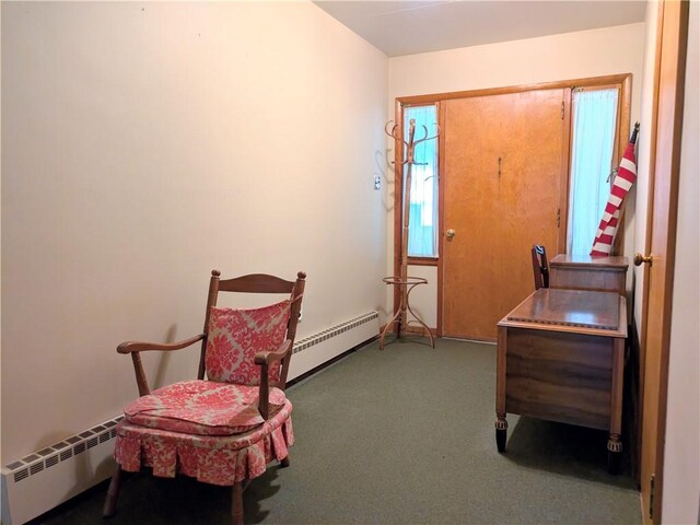 interior space featuring carpet flooring and a baseboard heating unit