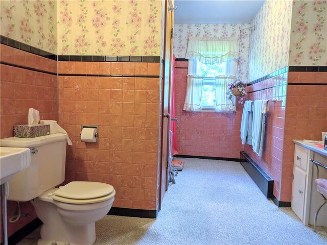 bathroom with tile walls and toilet