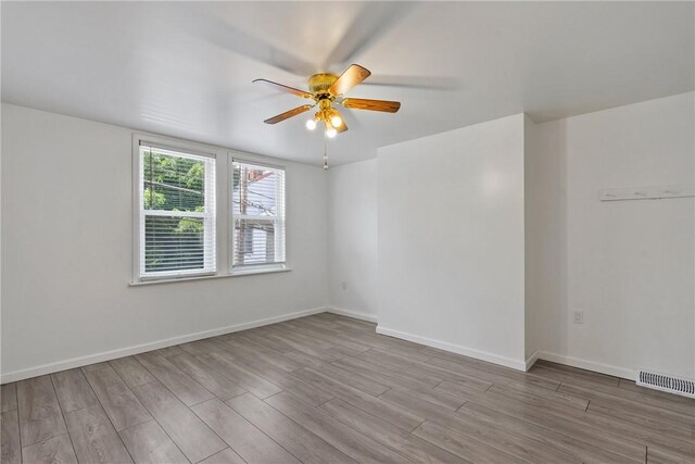 spare room featuring ceiling fan and light hardwood / wood-style floors