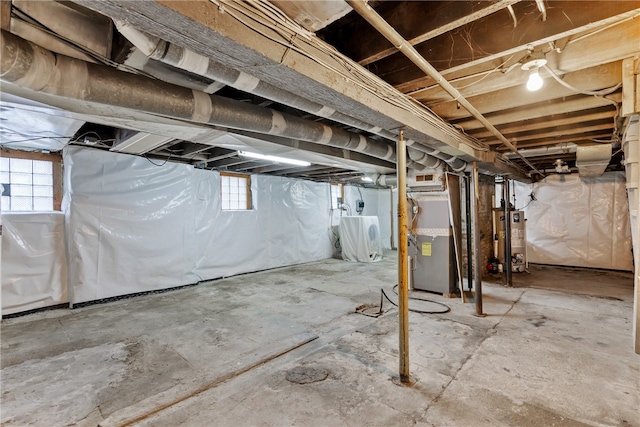 basement featuring heating unit and gas water heater