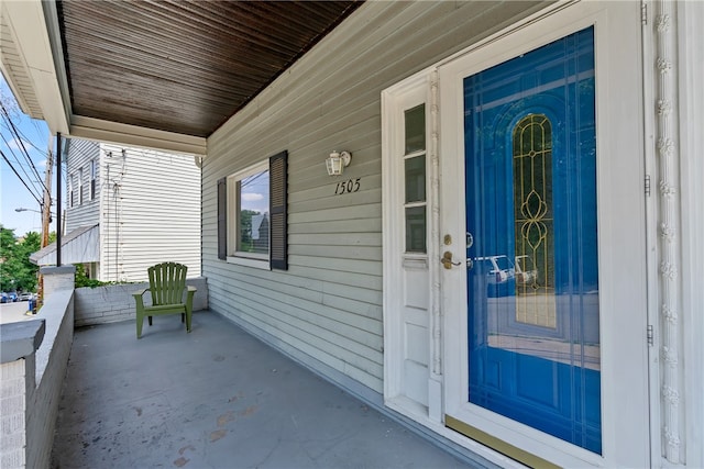 view of exterior entry with a porch