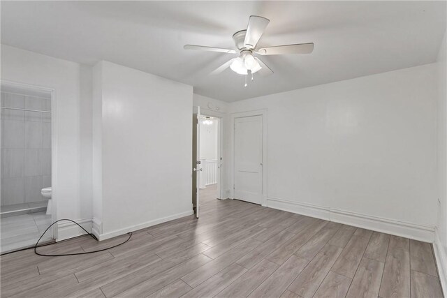 empty room with light hardwood / wood-style flooring and ceiling fan