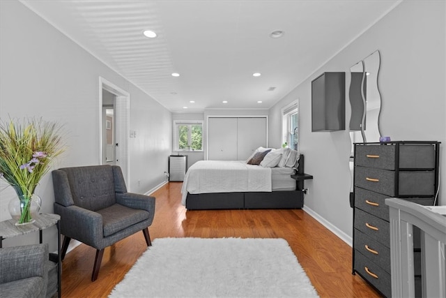 bedroom featuring light hardwood / wood-style flooring and multiple windows