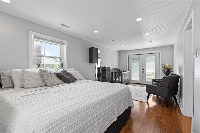 bedroom with dark hardwood / wood-style floors, ornamental molding, access to outside, and french doors