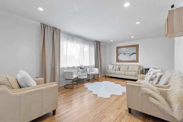 living room with light hardwood / wood-style flooring and ornamental molding